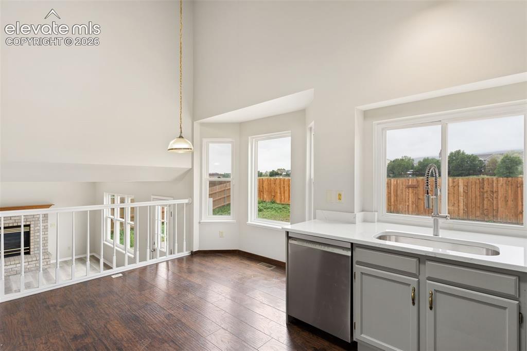 Image 12 of 38: Kitchen area featuring wood-finish flooring, white countertops, gray cabine