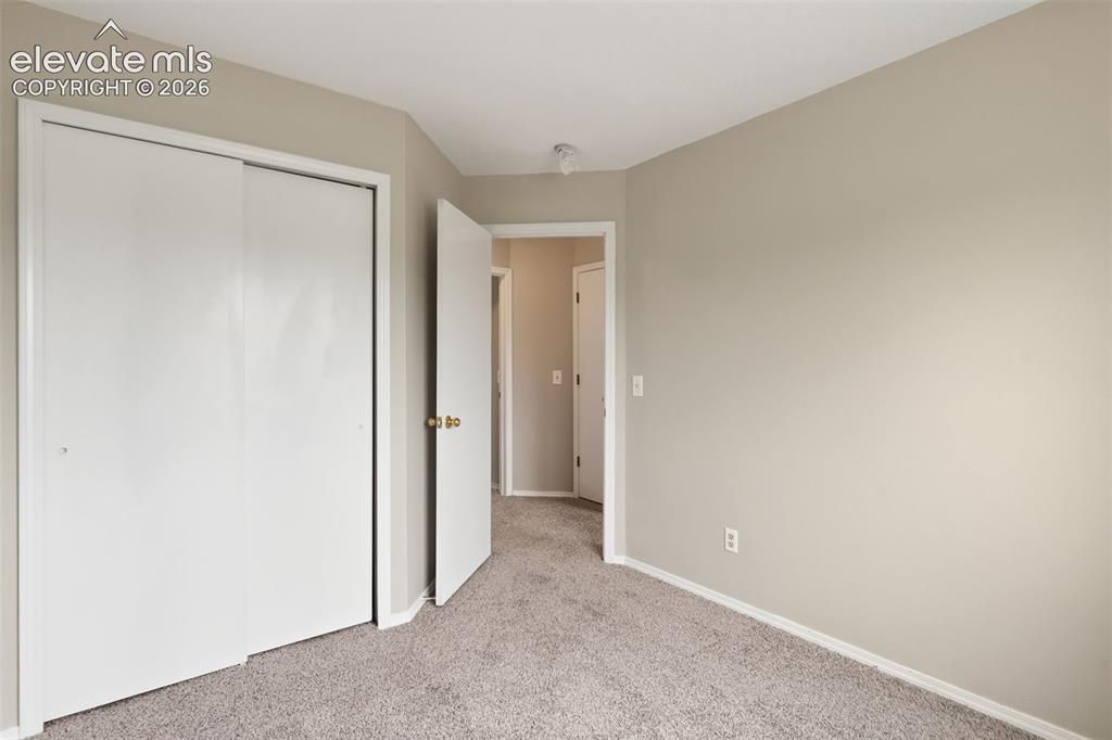 Image 29 of 38: Neutral tone wall finishes with plush carpet flooring