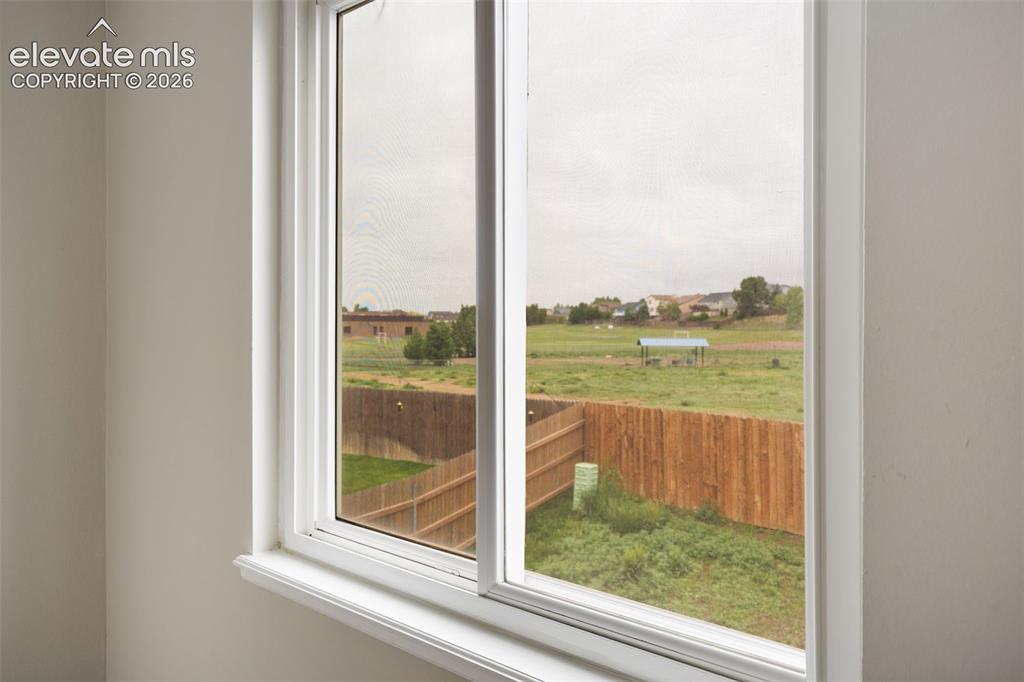 Image 30 of 38: Sliding window unit with white trim and a deep sill