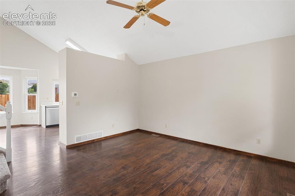 Image 4 of 38: Interior space featuring rich wood-finish flooring and a neutral color pale