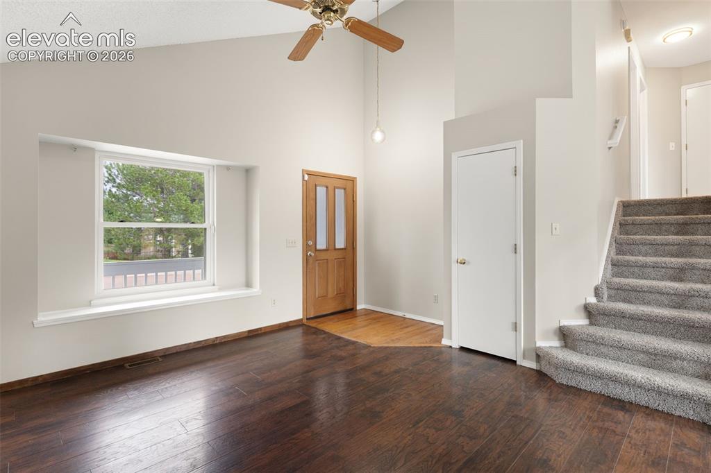 Image 5 of 38: Entryway featuring wood-finish flooring, a wood paneled door, a picture win