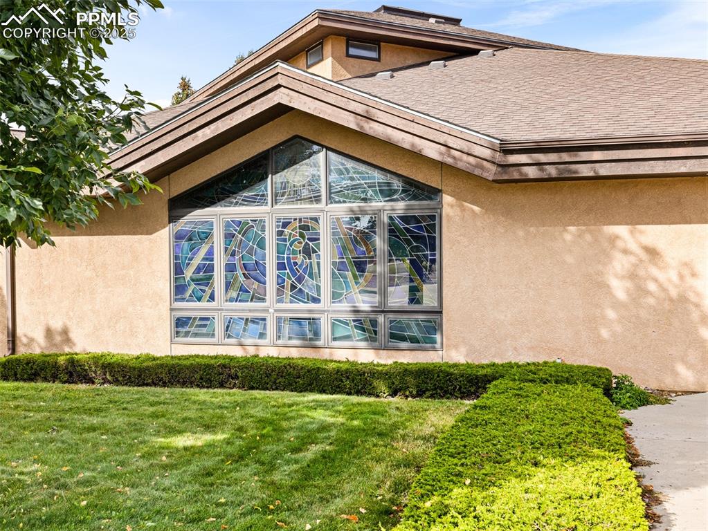 Image 2 of 49: View of property exterior featuring stucco siding and a yard