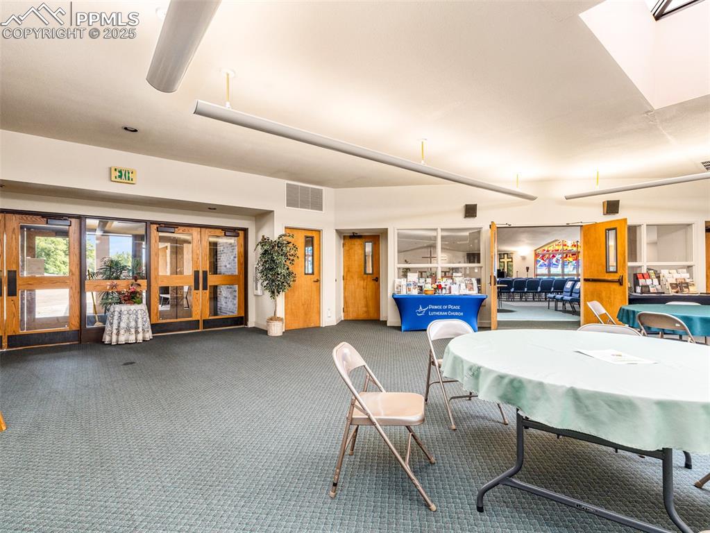 Image 49 of 49: Dining space featuring carpet flooring