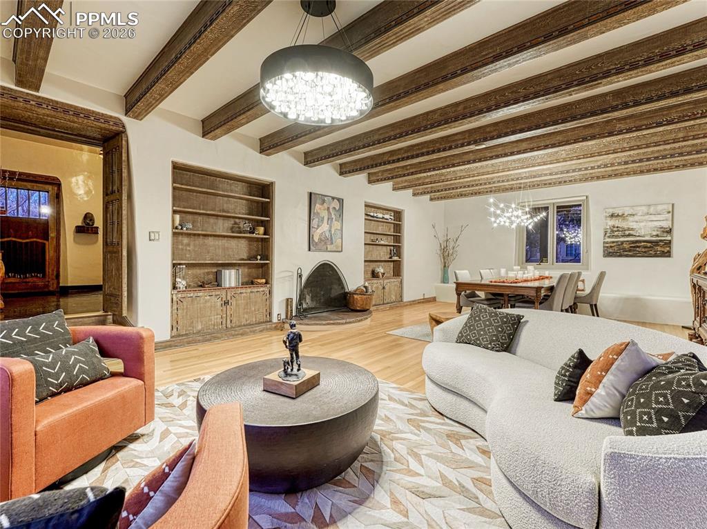 Image 14 of 50: Main entrance with original beamed ceiling, door and light fixtures.