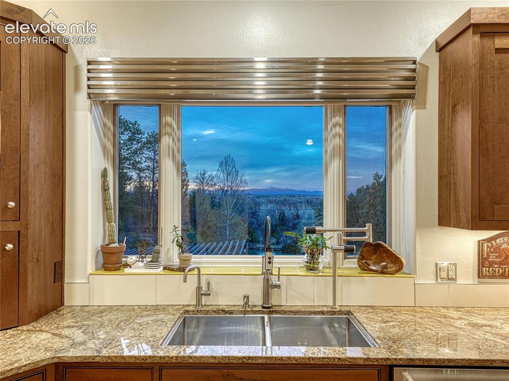 Image 14 of 50: One of two sink/dishwasher/prep spaces w/Pikes Peak views.