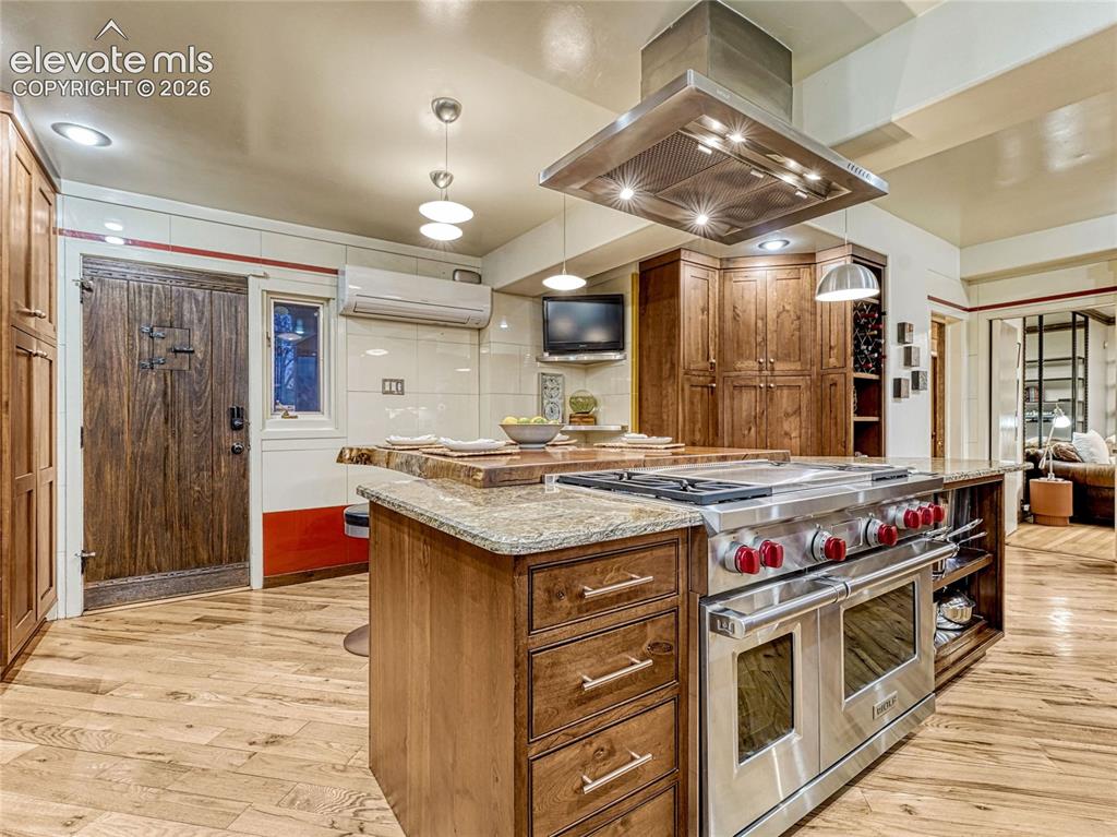 Image 15 of 50: Kitchen rooted in character, such as the original Vitrolite wall tile, upda