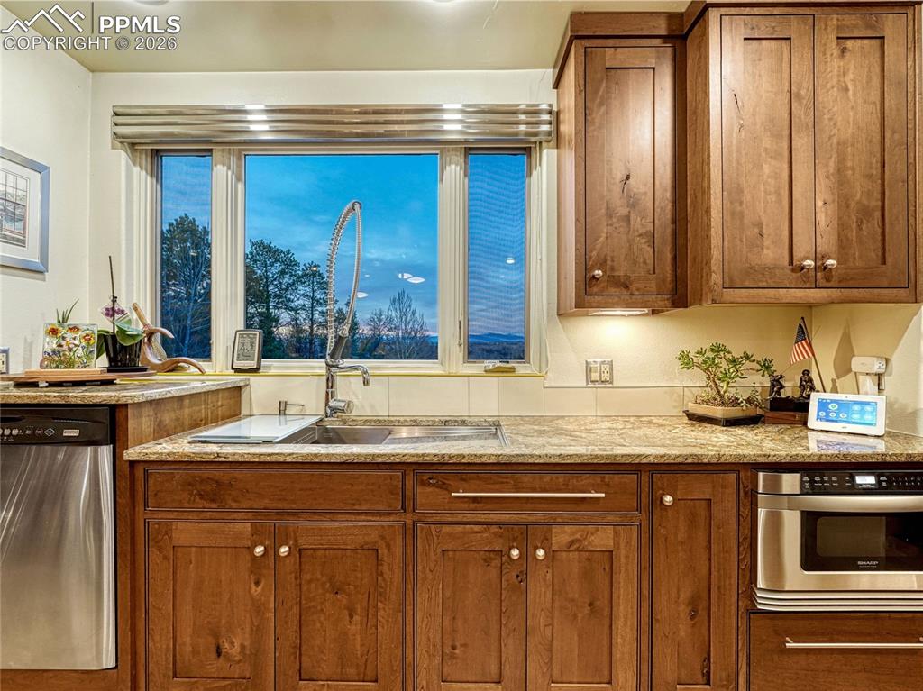 Image 18 of 50: Grand living/dining space with beamed ceiling and hardwood flooring.