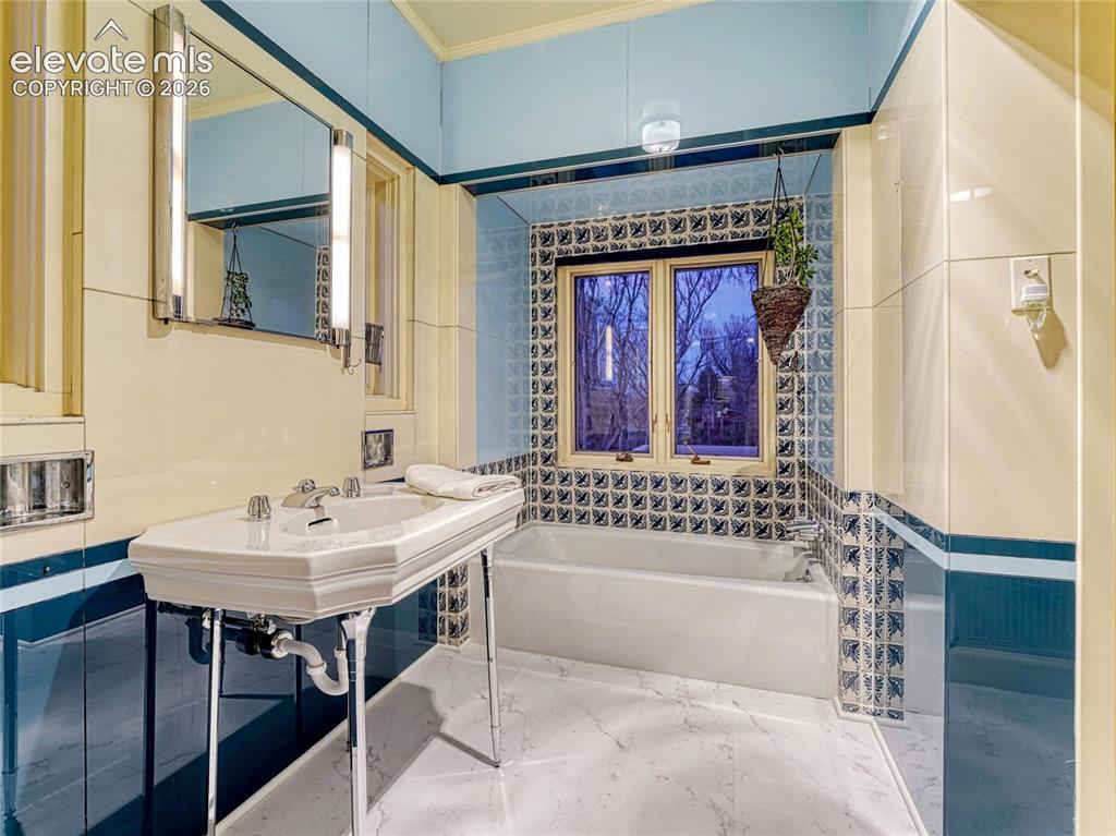 Image 26 of 50: Primary ensuite with original 1939 sink and finishes.