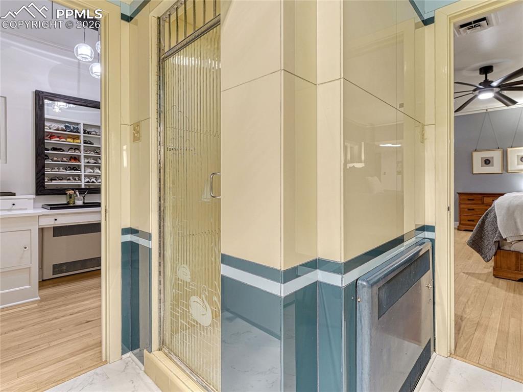 Image 29 of 50: Primary Suite sitting room has built-in bookcases with hand-carved, hand-pa