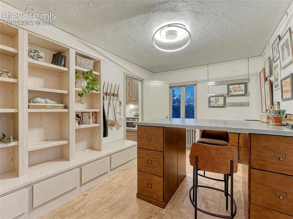 Image 30 of 50: Bedroom #4/office on main level w/built-ins plus closet space and private b