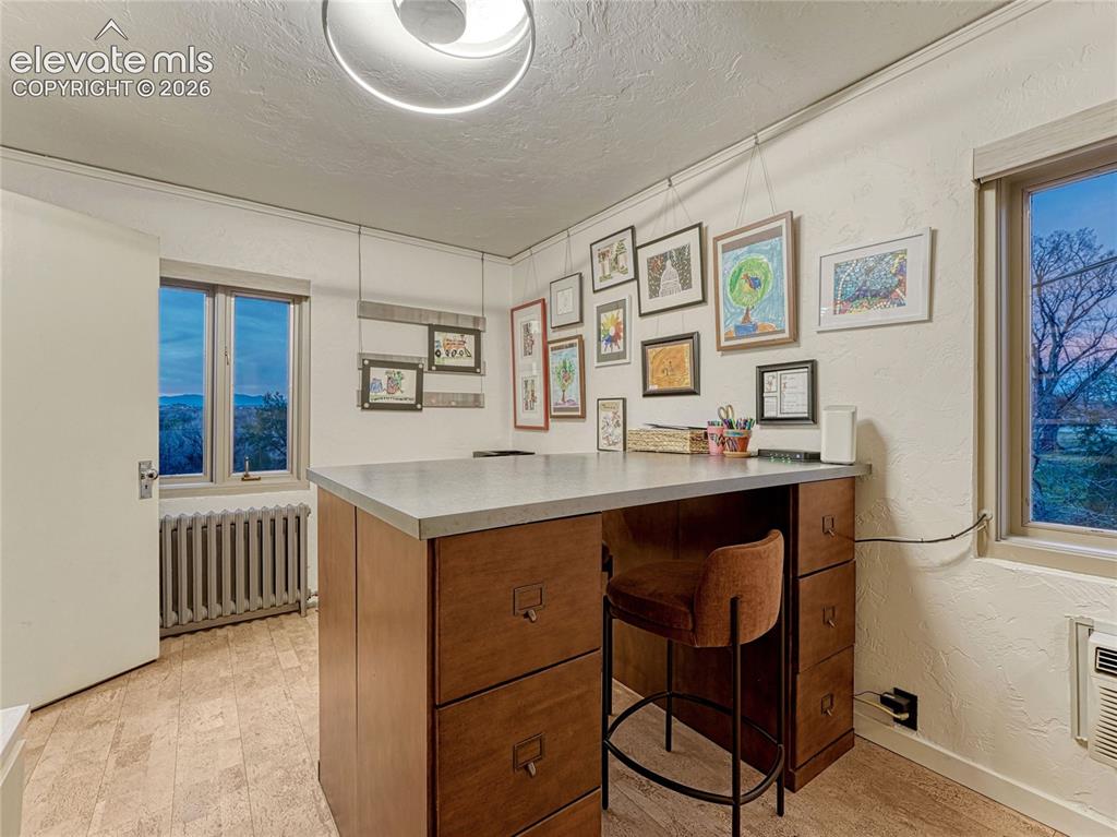 Image 31 of 50: Bedroom #4/office on main level w/built-ins plus closet space and private b