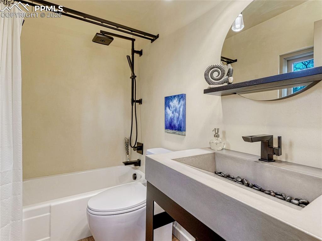 Image 38 of 50: Bedroom on main level with shared bath.