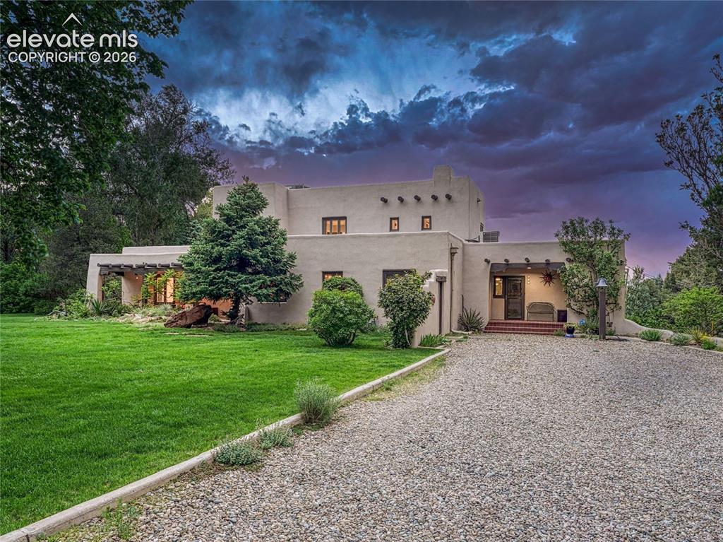 Image 4 of 50: Classic Pueblo Revival façade with timeless presence