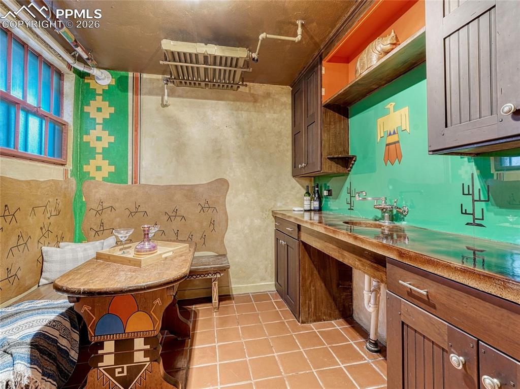 Image 41 of 50: Bedroom/office on main level w/built-ins plus closet space and private bath