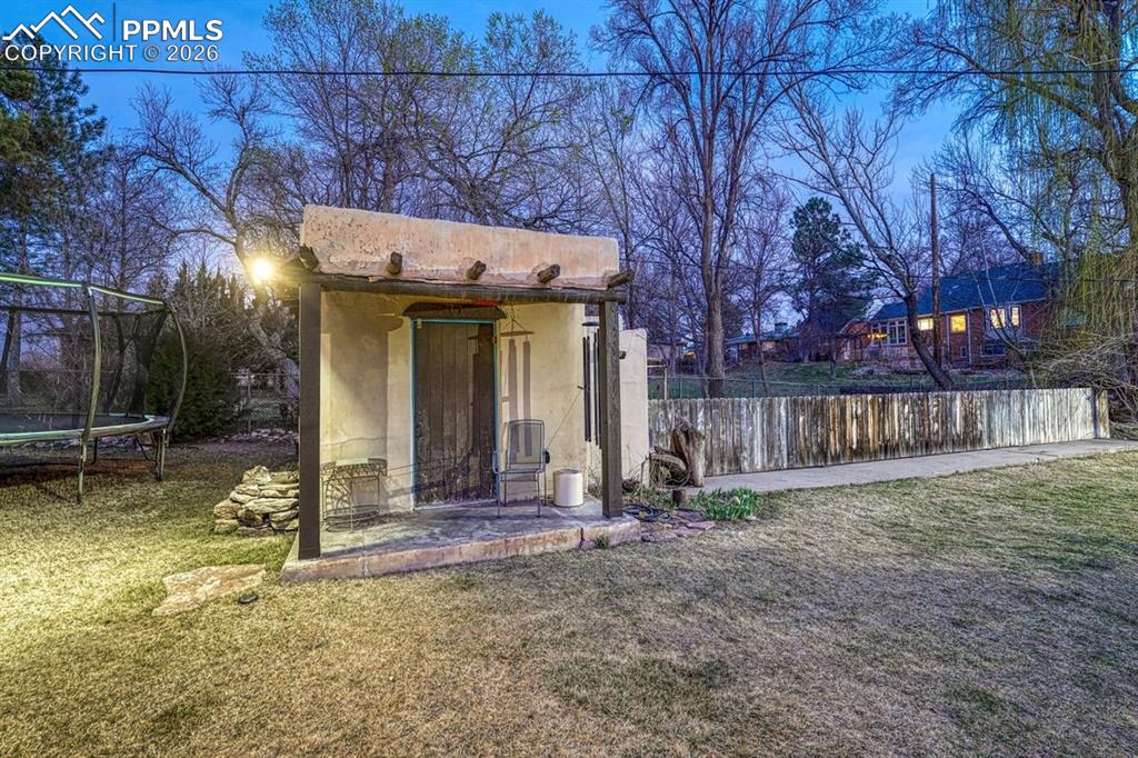 Image 44 of 50: Lower level family room with built-ins, cantina/wet bar and sliding glass d