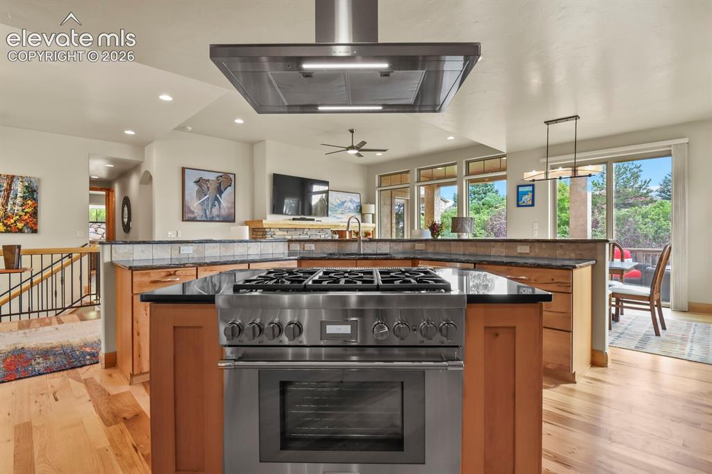 Image 12 of 48: Gourmet kitchen island with stainless steel Thermador range/double ovens an
