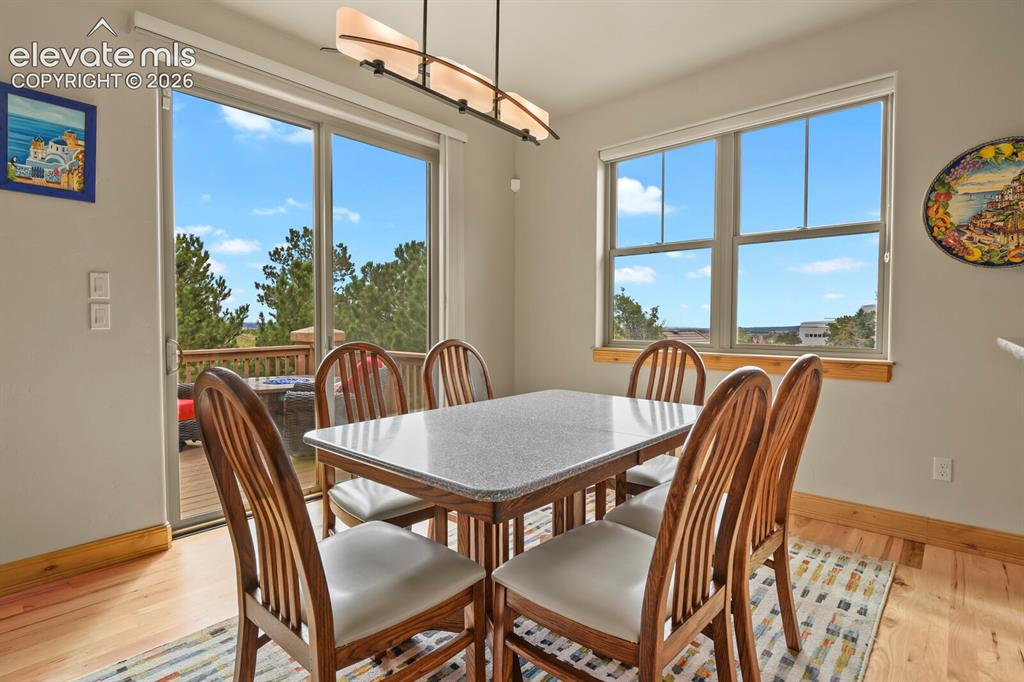 Image 14 of 48: Hardwood flooring, sliding glass door, to patio/deck, recessed lighting, an
