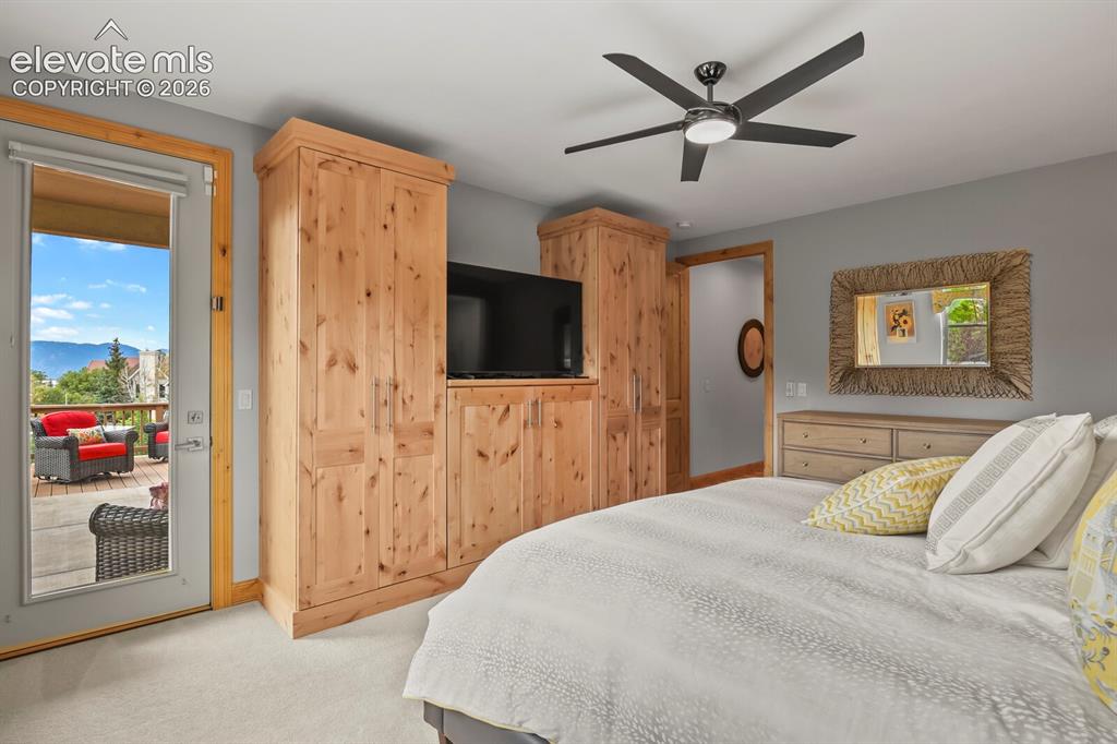 Image 19 of 48: Direct balcony access, natural wood-finish built-in cabinetry, ceiling fan 