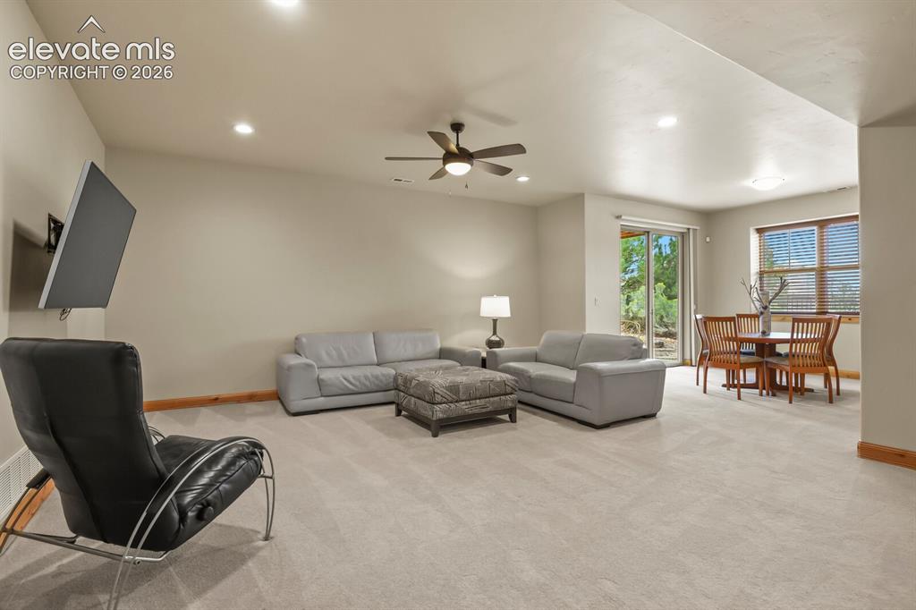 Image 26 of 48: Recessed lighting, ceiling fan, wall-mounted television bracket, sliding gl