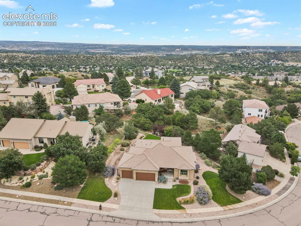 Image 42 of 48: Lovely home featuring a three-car garage, mature landscaping, and a tiled r
