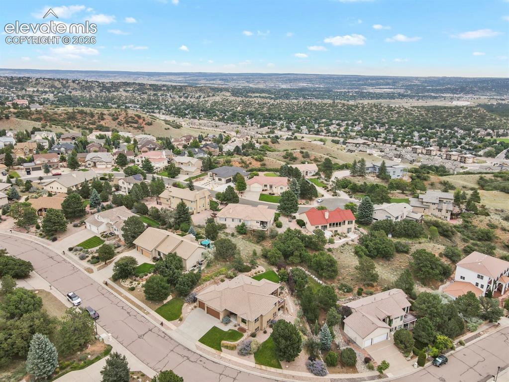 Image 43 of 48: Residential neighborhood with mature trees, city and mountain views.
