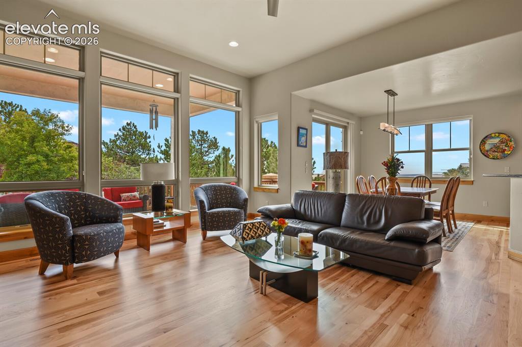 Image 8 of 48: Expansive living space featuring wood-finish flooring, recessed lighting, a