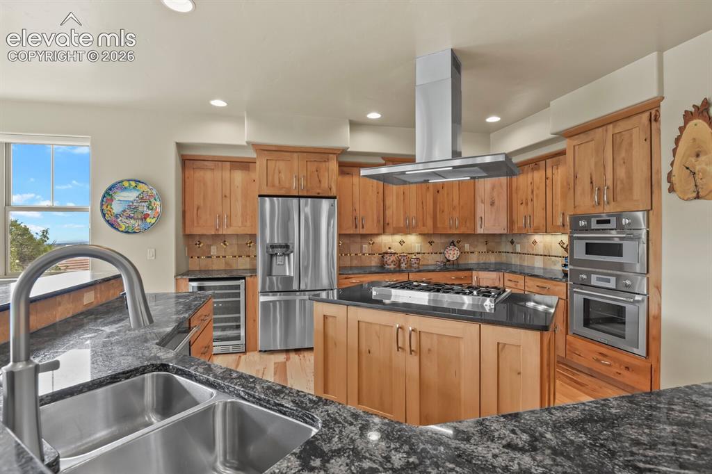 Image 9 of 48: Gourmet kitchen featuring custom hickory cabinetry, granite countertops, st