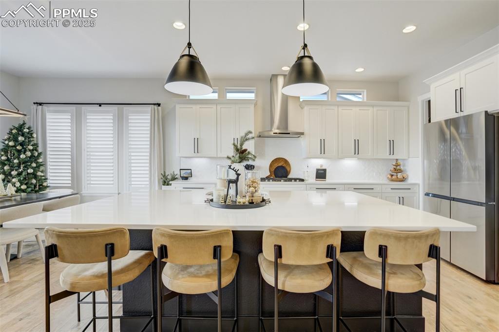 Image 13 of 47: Gourmet kitchen with upgraded appliances, quartz counters, beverage fridge,