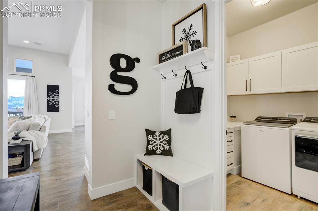 Image 17 of 47: Mudroom adjacent to laundry which features custom cabinetry and a sink