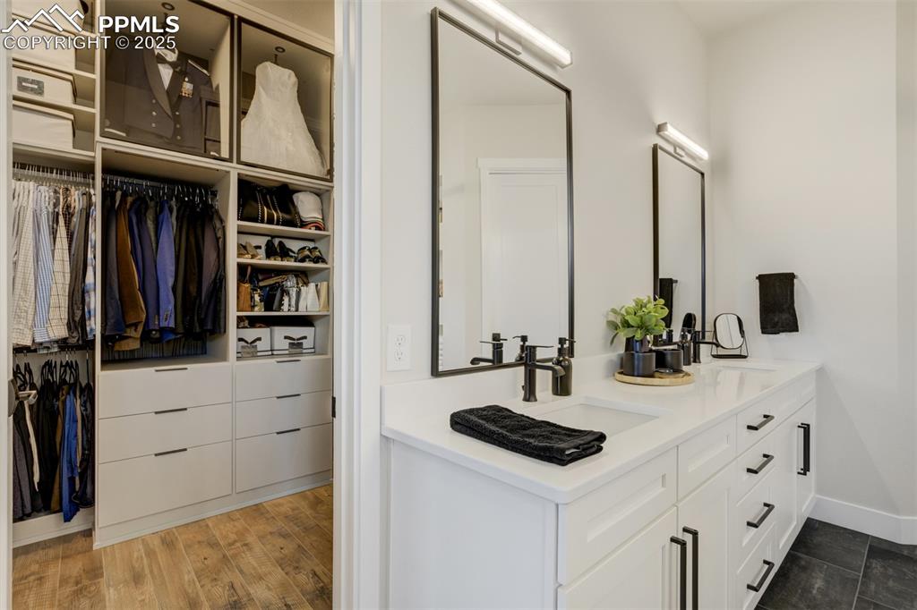 Image 21 of 47: Master closet designed by California Closets