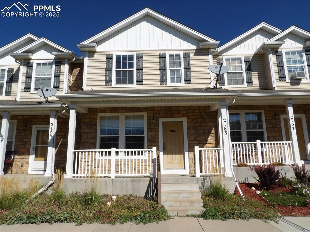 Caption: Craftsman house featuring stone siding, board and batten siding, and a porch