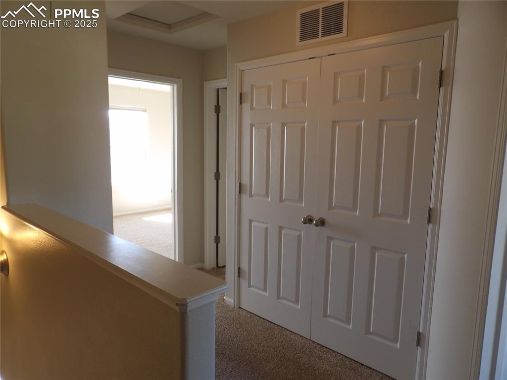 Image 14 of 20: Hallway featuring light carpet