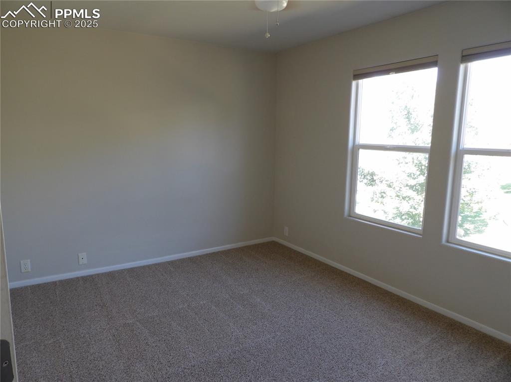 Image 15 of 20: Empty room featuring carpet floors and baseboards
