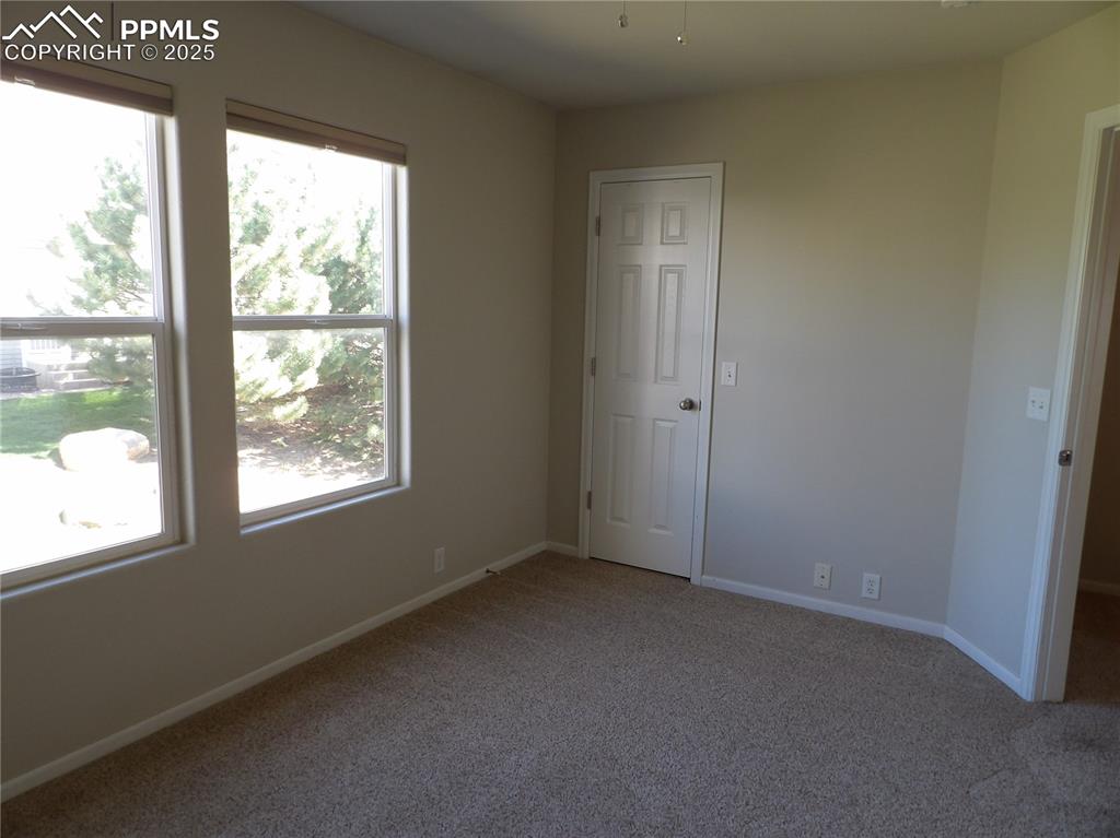 Image 16 of 20: Unfurnished bedroom with carpet floors and baseboards