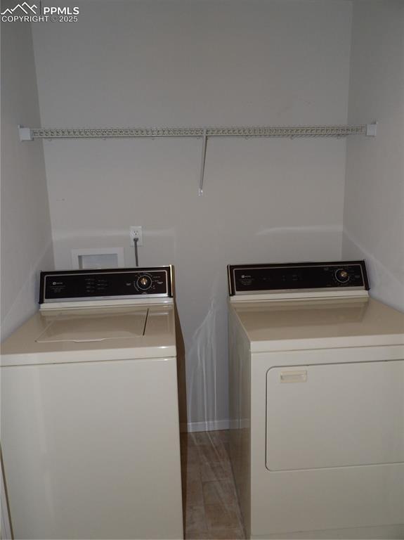 Image 17 of 20: Laundry room featuring washing machine and clothes dryer