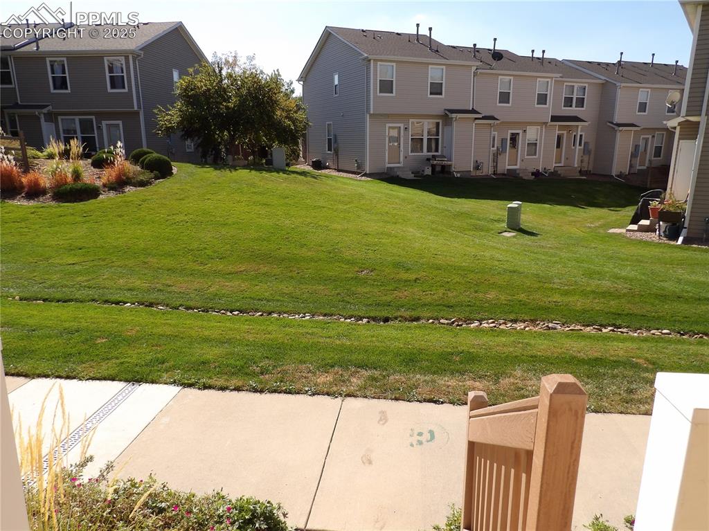 Image 2 of 20: View of green lawn featuring a residential view