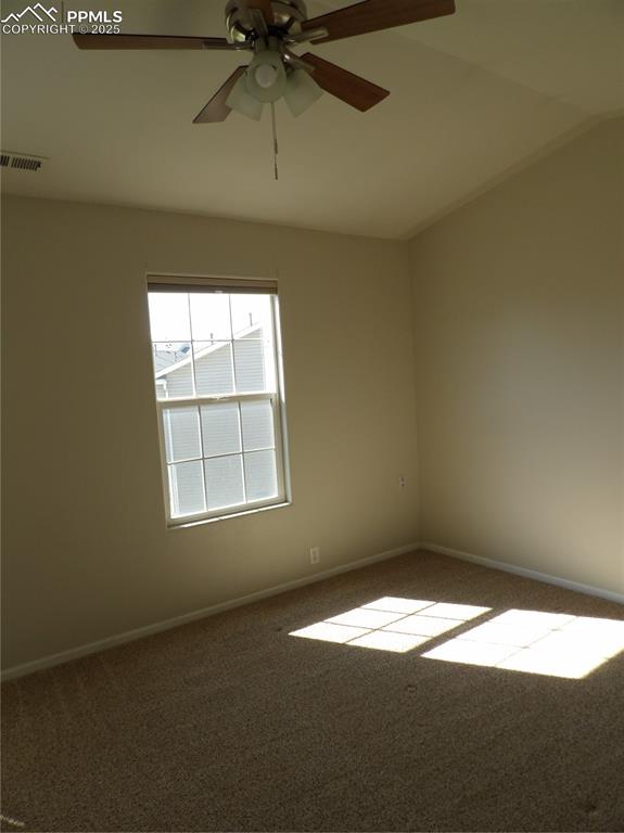 Image 20 of 20: Carpeted spare room with a ceiling fan and lofted ceiling