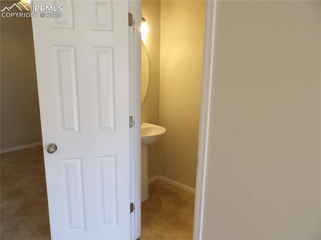 Image 7 of 20: Half bath featuring baseboards and light tile patterned floors