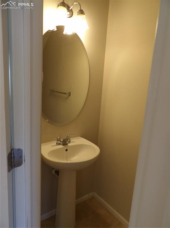Image 9 of 20: Bathroom with tile patterned flooring and baseboards