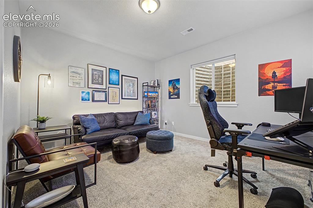 Image 44 of 50: Neutral-toned walls complement the light-colored carpet flooring