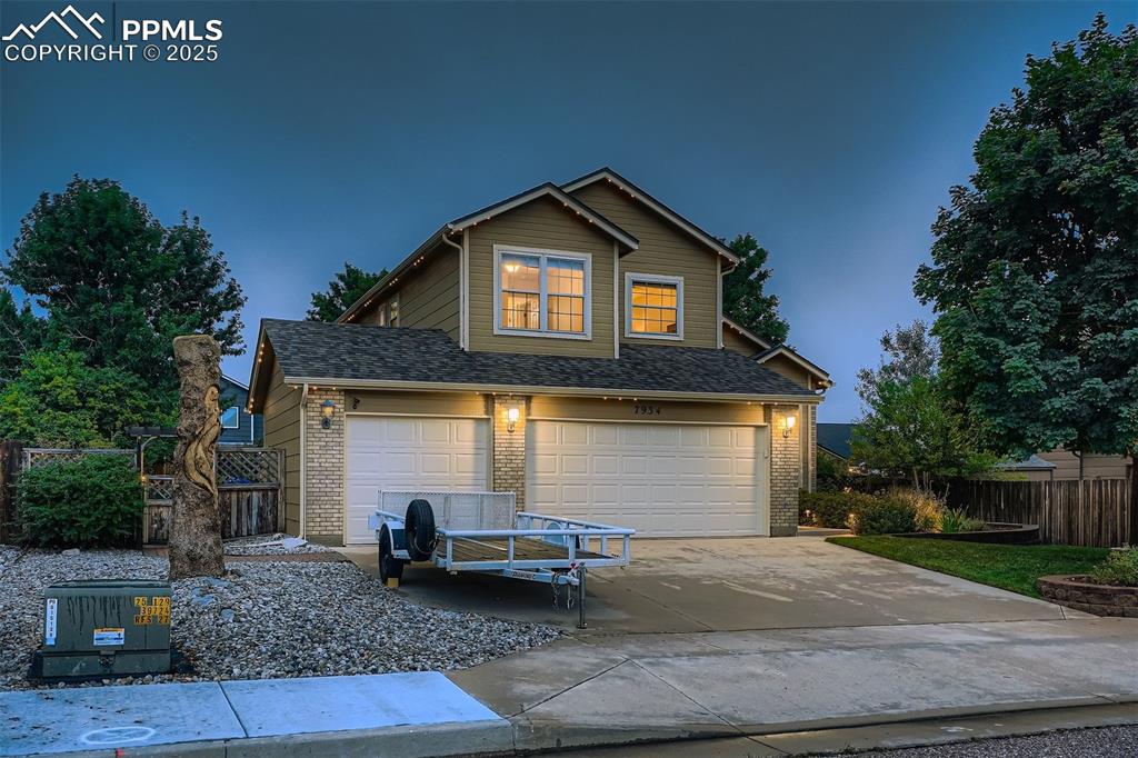 Caption: Featuring a 3 car garage, trim light around the entire home, & lux landscaping.