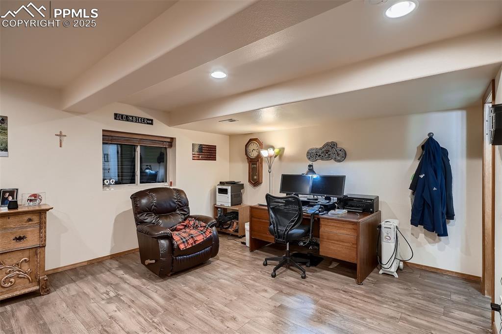 Image 20 of 28: A section of the downstairs currently used as an office.