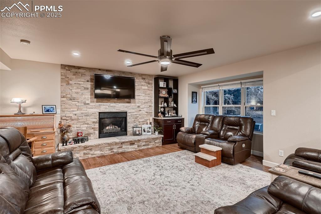 Image 9 of 28: Cozy gas fireplace, and Hardwood throughout the main level.