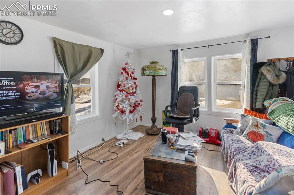 Image 11 of 37: The living area with wood finished floors and baseboards!