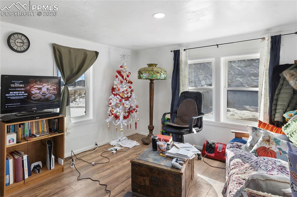 Image 14 of 37: Living room with wood finished floors and baseboards