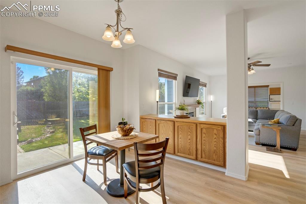 Image 11 of 50: Dining space with light wood-type flooring, healthy amount of natural light