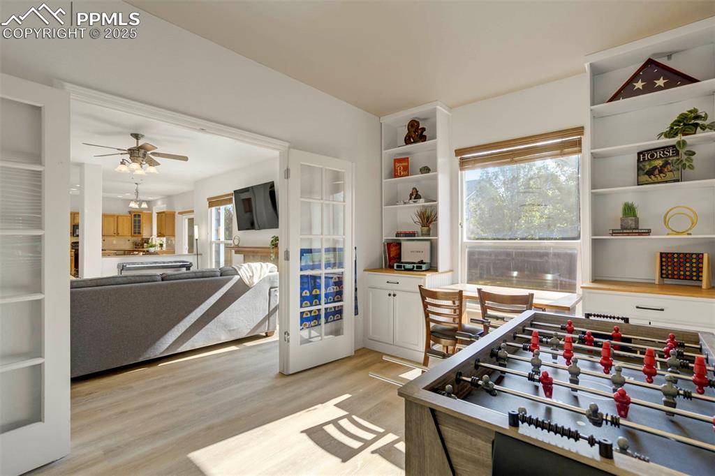 Image 16 of 50: Rec room with light wood-style flooring and a ceiling fan