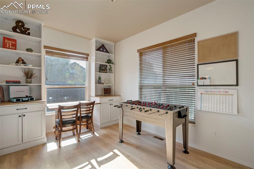 Image 17 of 50: Recreation room featuring light wood-style floors and baseboards