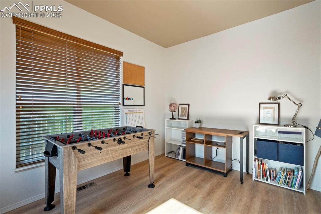 Image 19 of 50: Rec room featuring light wood-type flooring and baseboards