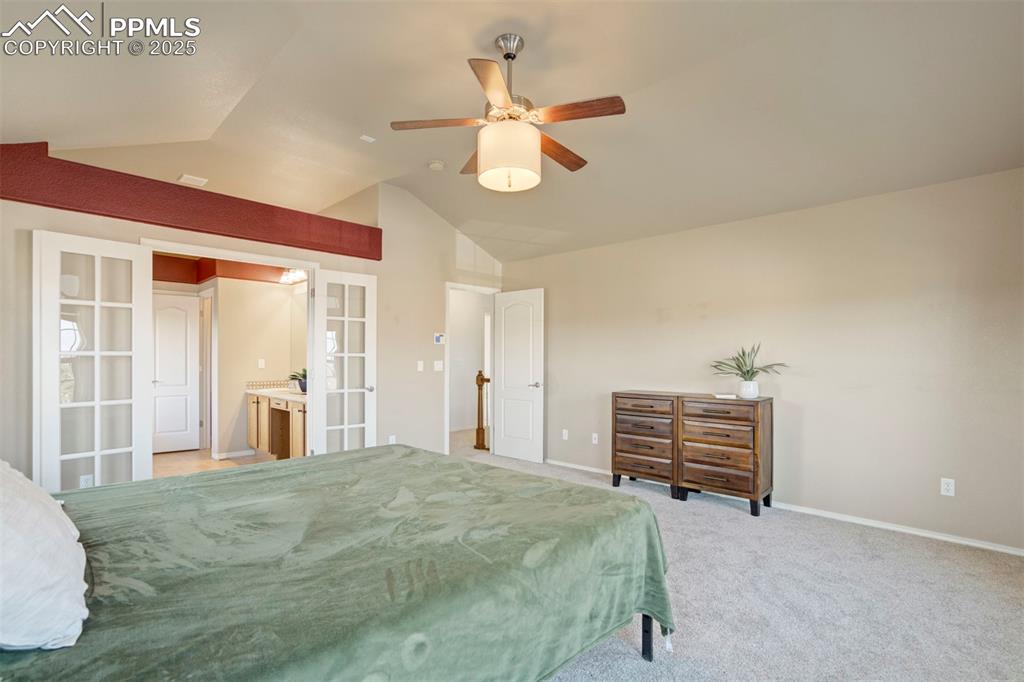 Image 26 of 50: Bedroom featuring french doors, light colored carpet, a ceiling fan, and lo
